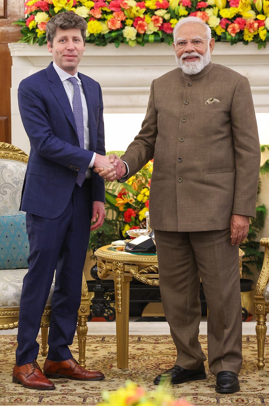 Narendra Modi and Sam Altman shaking hands in an official setting