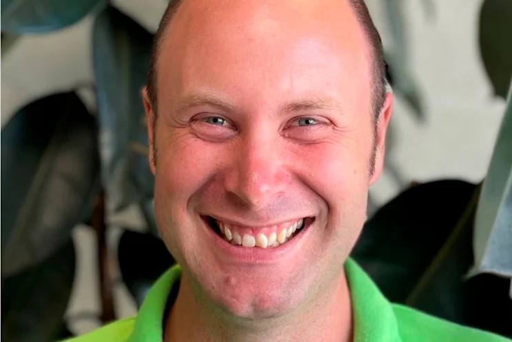Hamish Alexander Edward Tait, head and shoulders, smiling, in a green polo shirt