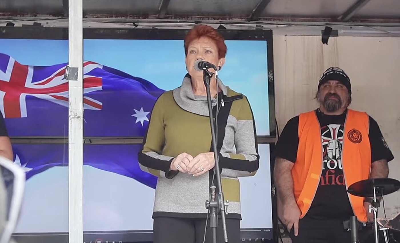 Pauline Hanson speaking at a rally, gesturing, microphone in front of her