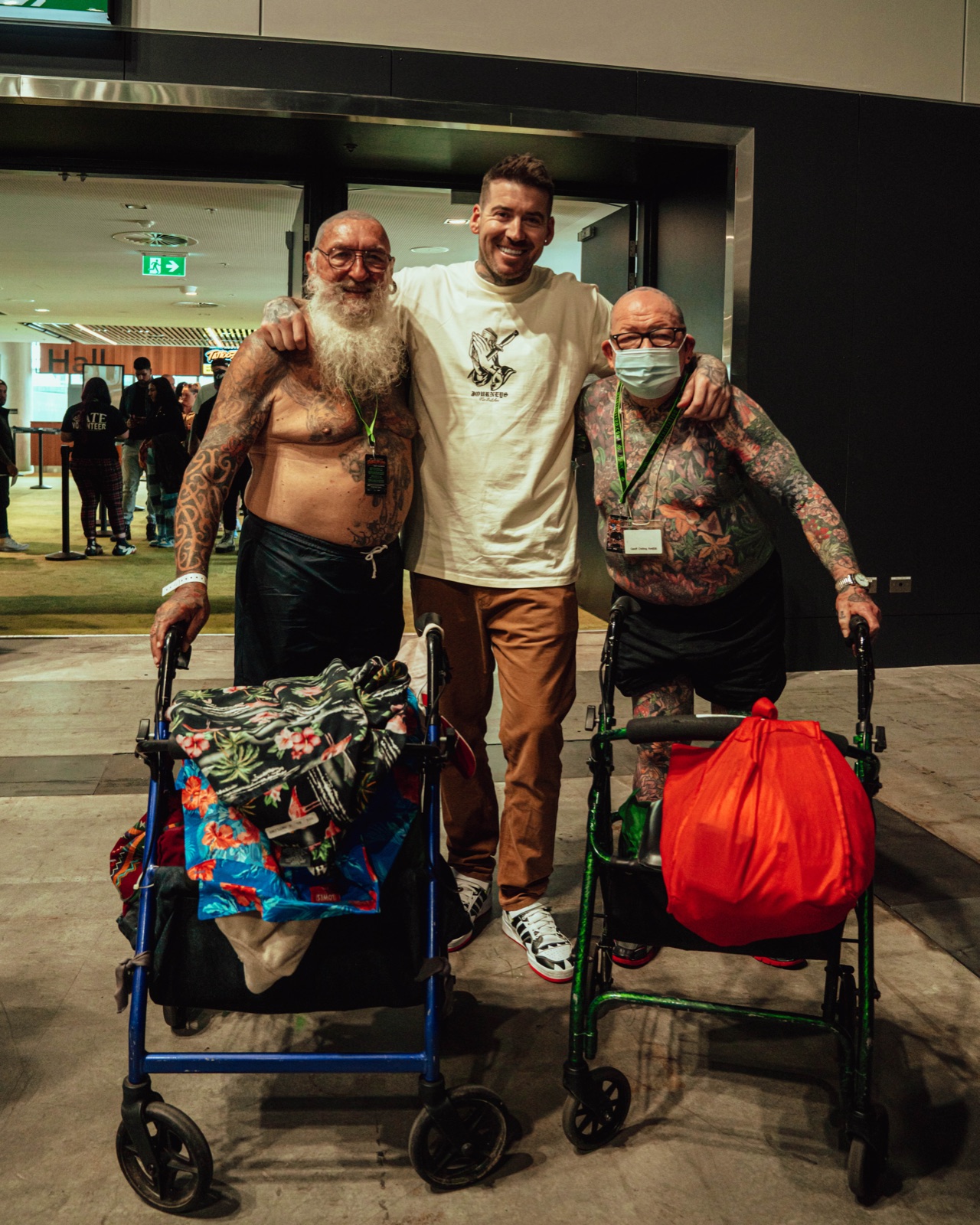 Kevin Mack with two attendees at the entrance of an exhibition hall